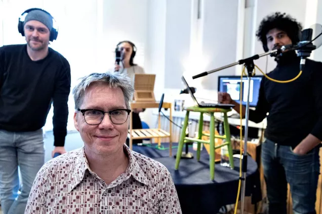 Fyra människor står i en inspelningsstudio. Fotografi